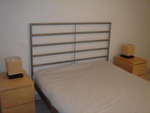 a bedroom with a bed with two dressers and two boxes at Apartamento MPS Jardines de Nuevo Vera in Vera