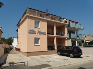 a building with a car parked in front of it at Apartments Villa Nona in Umag