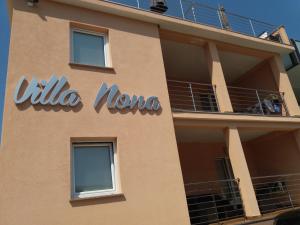 a sign on the side of a building at Apartments Villa Nona in Umag