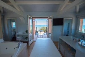 a large bathroom with a view of the ocean at Villa Lattanzi in Marina Palmense