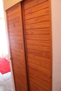 a wooden closet with a wooden door in a room at R&G Pineda Apartamento in La Pineda