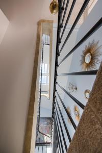 a glass staircase in a house with a ceiling at Le Clos Saluces in Avignon