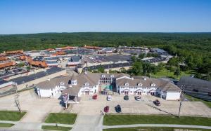 an aerial view of a large building with a parking lot at Osage Village Inn in Osage Beach