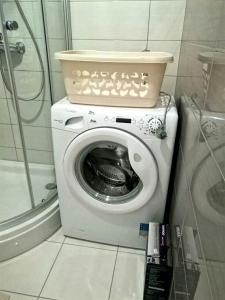 a washing machine with a bowl on top of it at Malik's place in Novalja