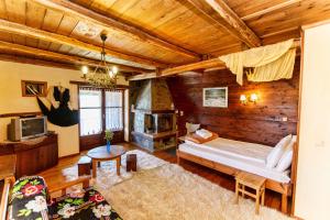 a bedroom with a bed and a fireplace at Arxontiko Agonari in Metamorfosi