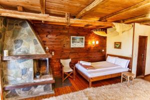 a bedroom with a bed and a fireplace at Arxontiko Agonari in Metamorfosi
