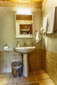 a bathroom with a sink and a mirror at Arxontiko Agonari in Metamorfosi