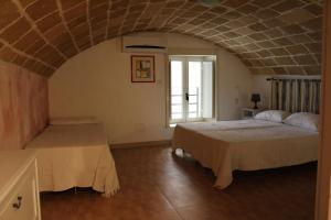 En eller flere senge i et værelse på Le Perle dello Jonio