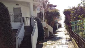 an alley with stairs leading up to a building at Sakis in Siviri