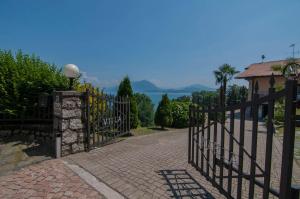a stone wall with a fence and a fence post at Villa Maria in Stresa