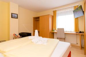 Postel nebo postele na pokoji v ubytování 1a Hotel Steiner