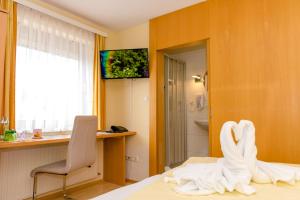 Postel nebo postele na pokoji v ubytování 1a Hotel Steiner