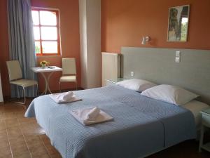 a bedroom with a bed with two towels on it at Ilona Apartments Chania in Kato Daratso +45 photos
