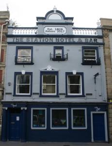 a blue building with a sign for the station hotel at The Station in Shrewsbury