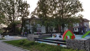a park with a playground with a slide at Lovac Motel & Restaurant in Donji Žabar +27 photos