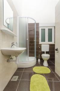 a bathroom with a sink and a toilet and a shower at Apartments Pava in Okrug Donji +94 photos