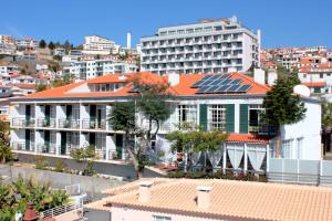 a group of buildings with solar panels on the roofs at Monte Verde in Funchal