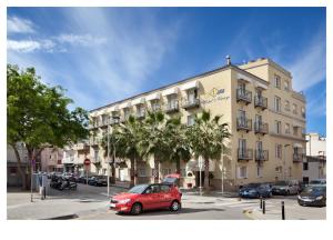 un coche rojo estacionado frente a un edificio en Hotel Ninays, en Lloret de Mar