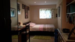 a small bedroom with a bed and a window at Lovely house in Cagnes-sur-Mer