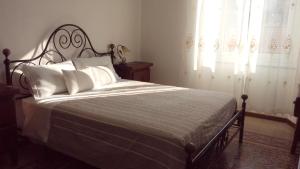 a bedroom with a large bed with white pillows at I Colori del Mercato in La Spezia