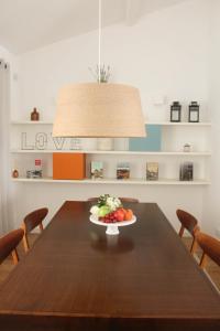 a table with a plate of food on top of it at Arco Apartments in Porto