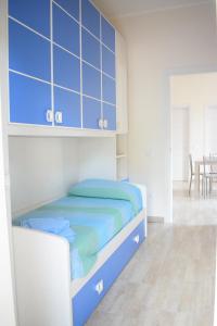 a bedroom with a bed and blue cabinets at Stefy Home in Catania