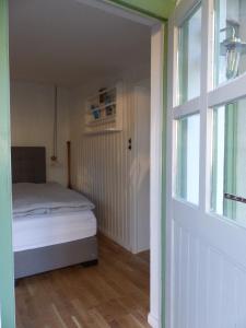 a small bedroom with a bed and a window at Feine Laube in Berlin