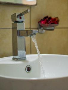 a sink with water coming out of a faucet at Sea View Suite Methana in Methana