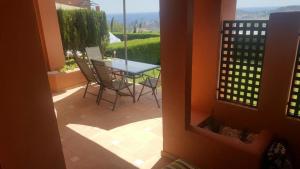 a patio with a table and chairs on a balcony at Luxyry apartament Benidorm in Finestrat