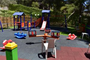 a playground with different types of play equipment at New Aegli Resort Hotel in Poros