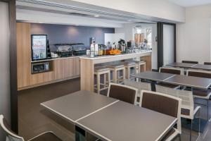 a dining room with tables and a bar at Microtel Inn and Suites by Wyndham Monahans in Monahans