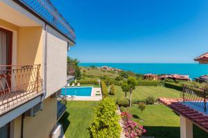 a view of the garden from the balcony of a building at Via Pontica 123 Guest Apartments in Sozopol