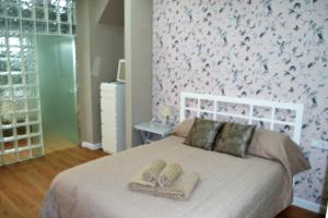 Posteľ alebo postele v izbe v ubytovaní DREAMSUITES MARIN GARCIA.