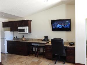 a kitchen with a table and a microwave at Winterton Suites in Williston