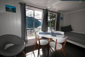 a room with a table and chairs and a window at Dalsøren Camping og hytter in Luster +77 photos