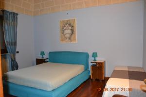 Postel nebo postele na pokoji v ubytování Masseria Fragnale