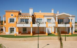 a large house with orange and white at The View – Santo António Villas, Golf & Spa in Salema