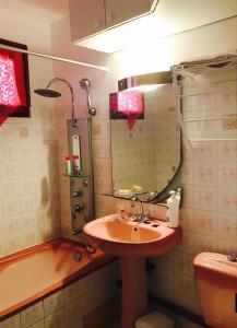 a bathroom with a sink and a tub and a mirror at Villa Kapiopa in Sainte-Anne