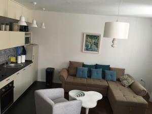 a living room with a couch and a table at Squere 44 Apartment in Budva