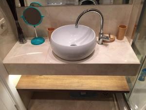 a bathroom sink with a white bowl sink at Squere 44 Apartment in Budva