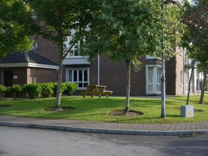 a park with a picnic table in front of a building at Coiribe House B&SelfBreakfast in Galway