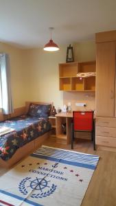a bedroom with a bed and a desk and a rug at Coiribe House B&SelfBreakfast in Galway