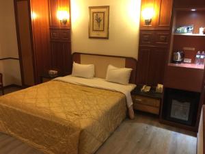 Postel nebo postele na pokoji v ubytování ChangSing Business Motel