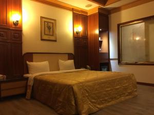 ChangSing Business Motel tesisinde bir odada yatak veya yataklar