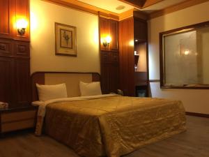 Postel nebo postele na pokoji v ubytování ChangSing Business Motel