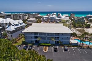 an aerial view of a resort with a parking lot and the ocean at Beachside Villas by Panhandle Getaways in Seagrove Beach