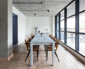 a dining room with a white table and chairs at Boro Hotel in Queens