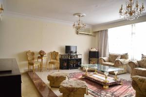 a living room with a couch and a table and chairs at Fancy apartment in front of City Stars in Cairo