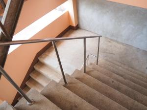 a set of stairs with a metal rail at Charinsup Hotel in Ban Khlong Thai Muang +1 photo