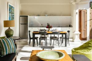 a kitchen and living room with a table and chairs at Villa Mandala in Seminyak